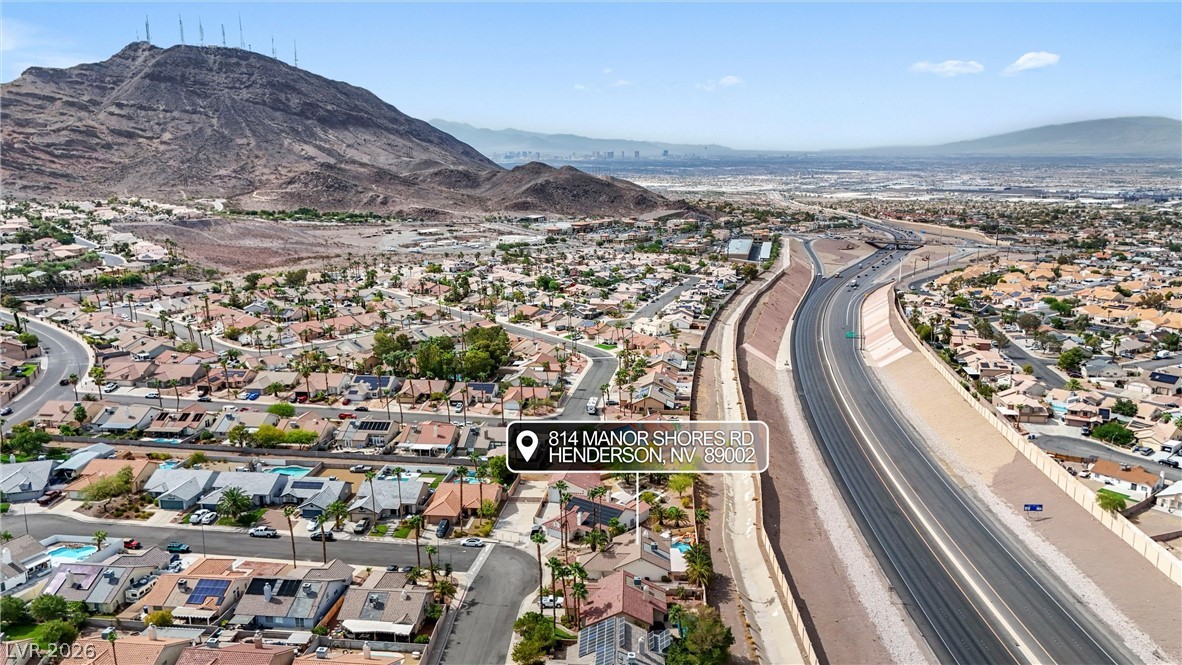 814 Manor Shores Road Henderson, NV 89002 - Photo 33 of 40 An aerial perspective captures the vast neighborhood landscape set against a dramatic mountain backdrop.