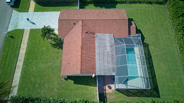 a swimming pool with potted plants in front of door