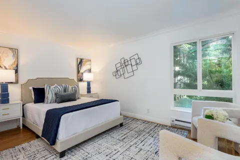 a bedroom with a large bed and a window