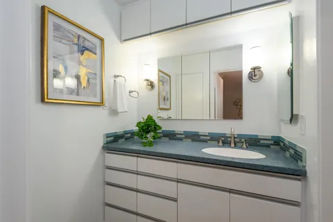 a bathroom with a sink vanity and a mirror