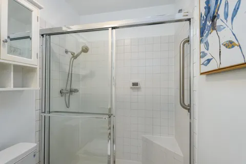 a bathroom with a glass shower door
