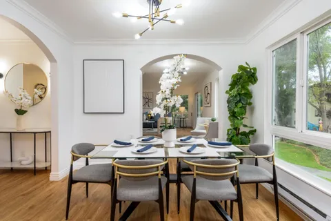a view of a dining room with furniture and wooden floor