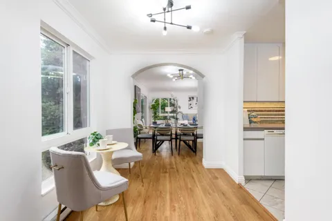 a view of a dining room with furniture and wooden floor