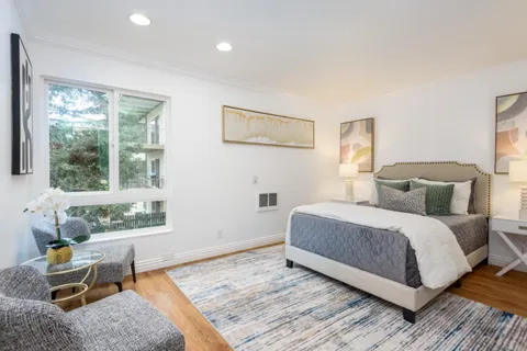 a bedroom with a bed and windows