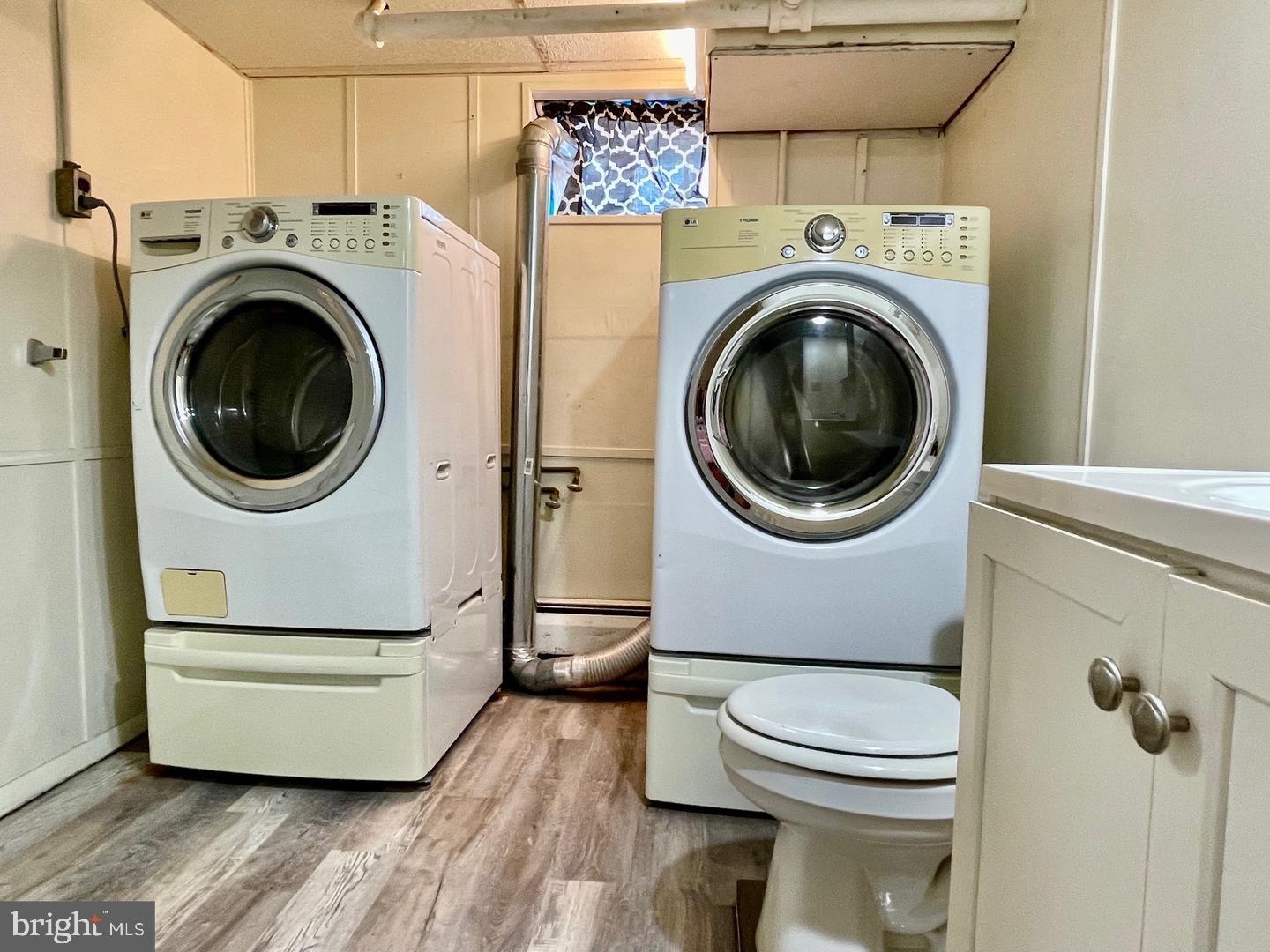 692 Lenni Road Aston, PA 19014 - Photo 21 of 28 a utility room with dryer washer and a wooden floor