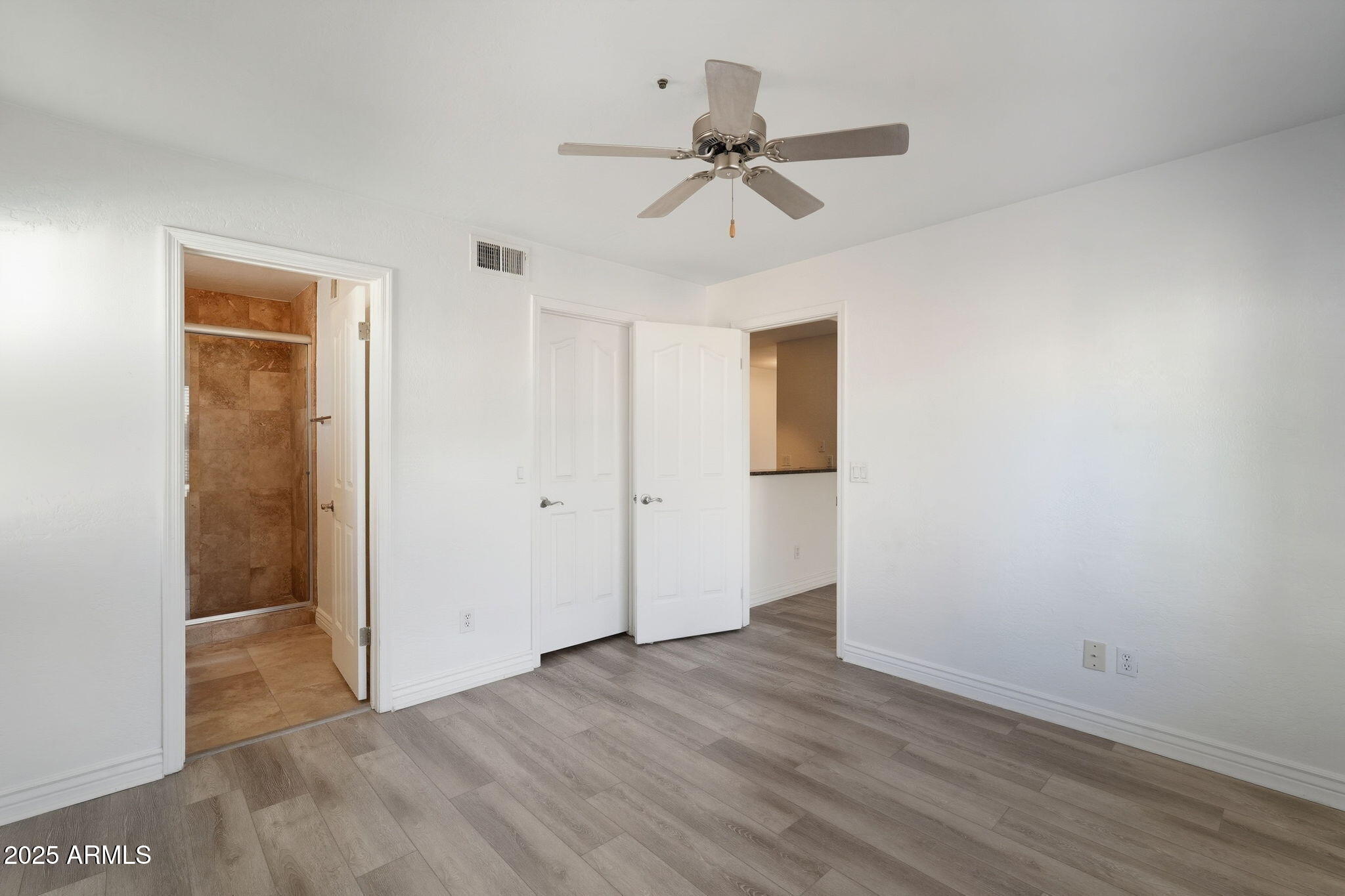 14145 North 92nd Street, Unit 2028 Scottsdale, AZ 85260 - Photo 12 of 24 a view of a room with wooden floor and a ceiling fan