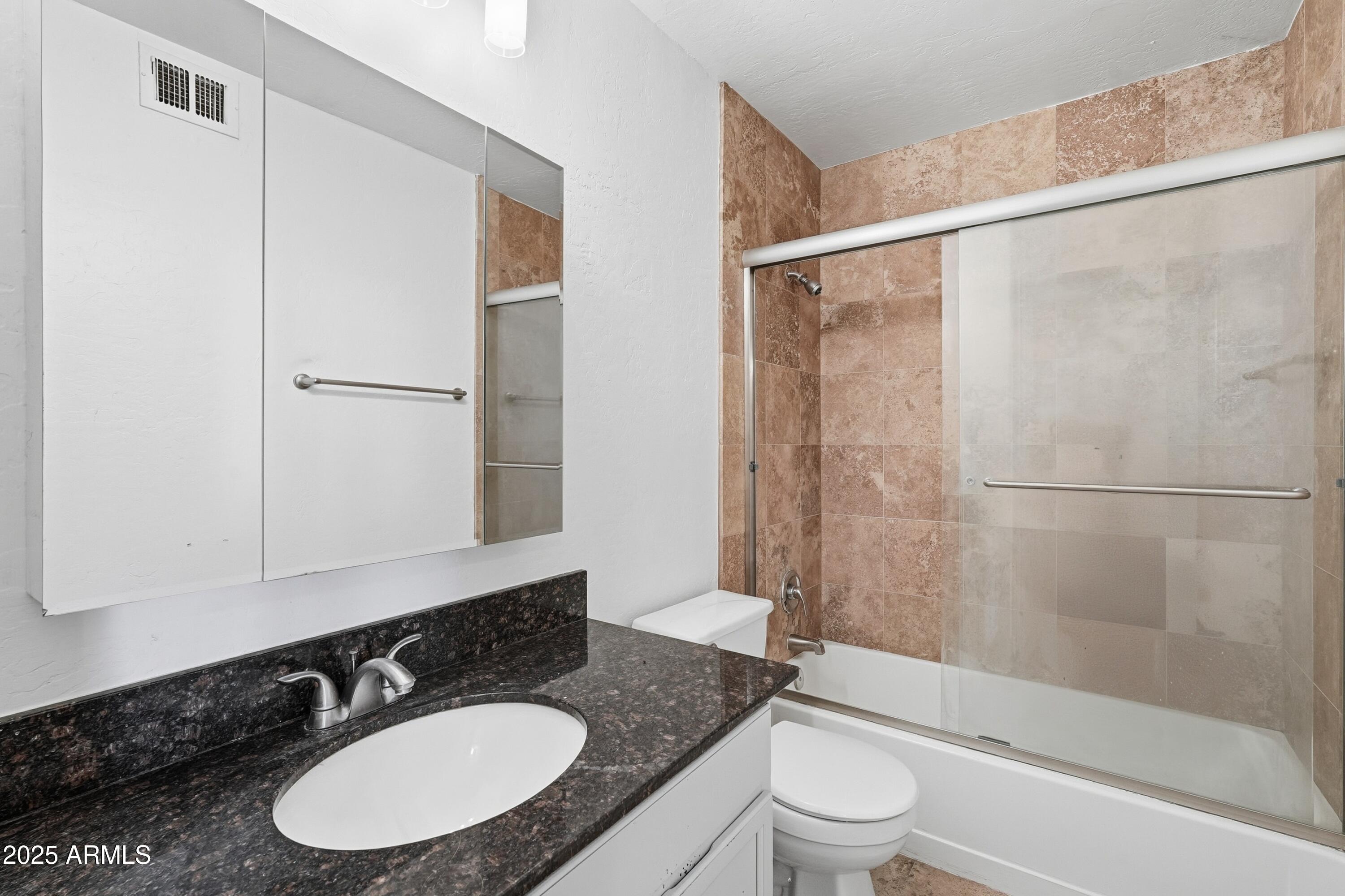14145 North 92nd Street, Unit 2028 Scottsdale, AZ 85260 - Photo 20 of 24 a bathroom with a sink and a mirror