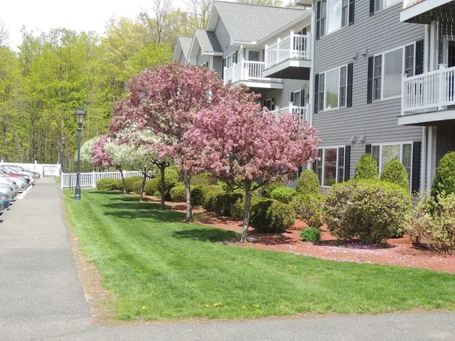 a view of a house with a yard and sitting area
