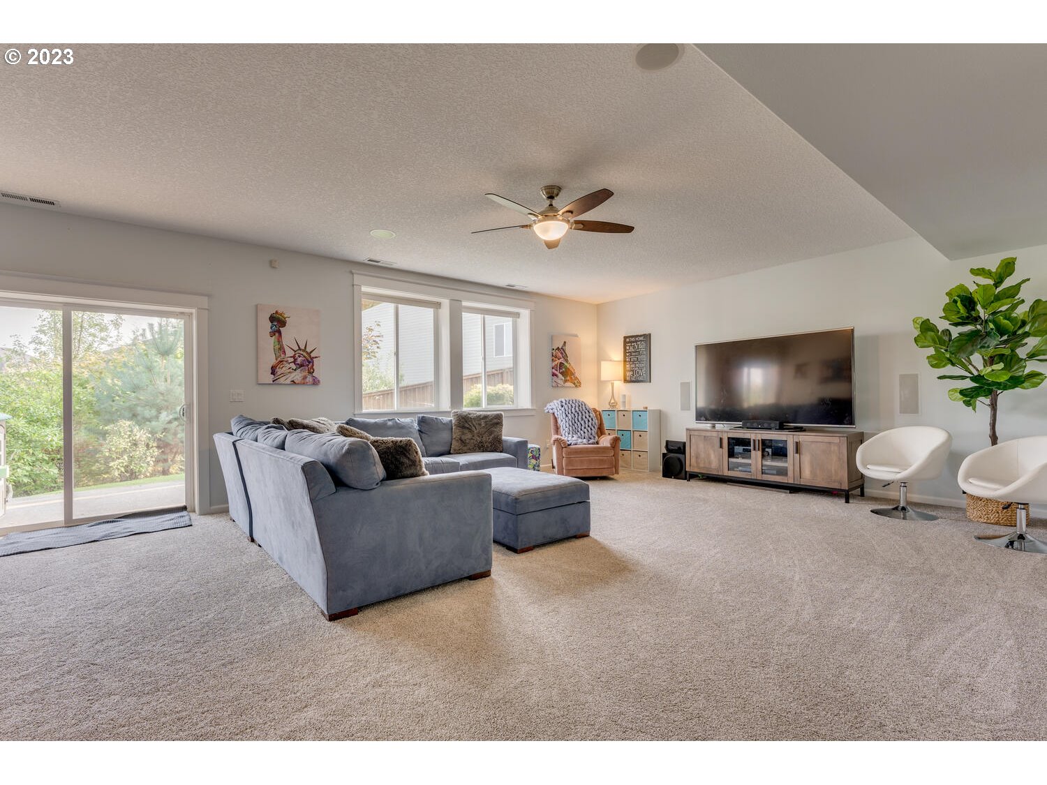 1913 South 15th Circle Ridgefield, WA 98642 - Photo 25 of 33 a living room with furniture and a flat screen tv