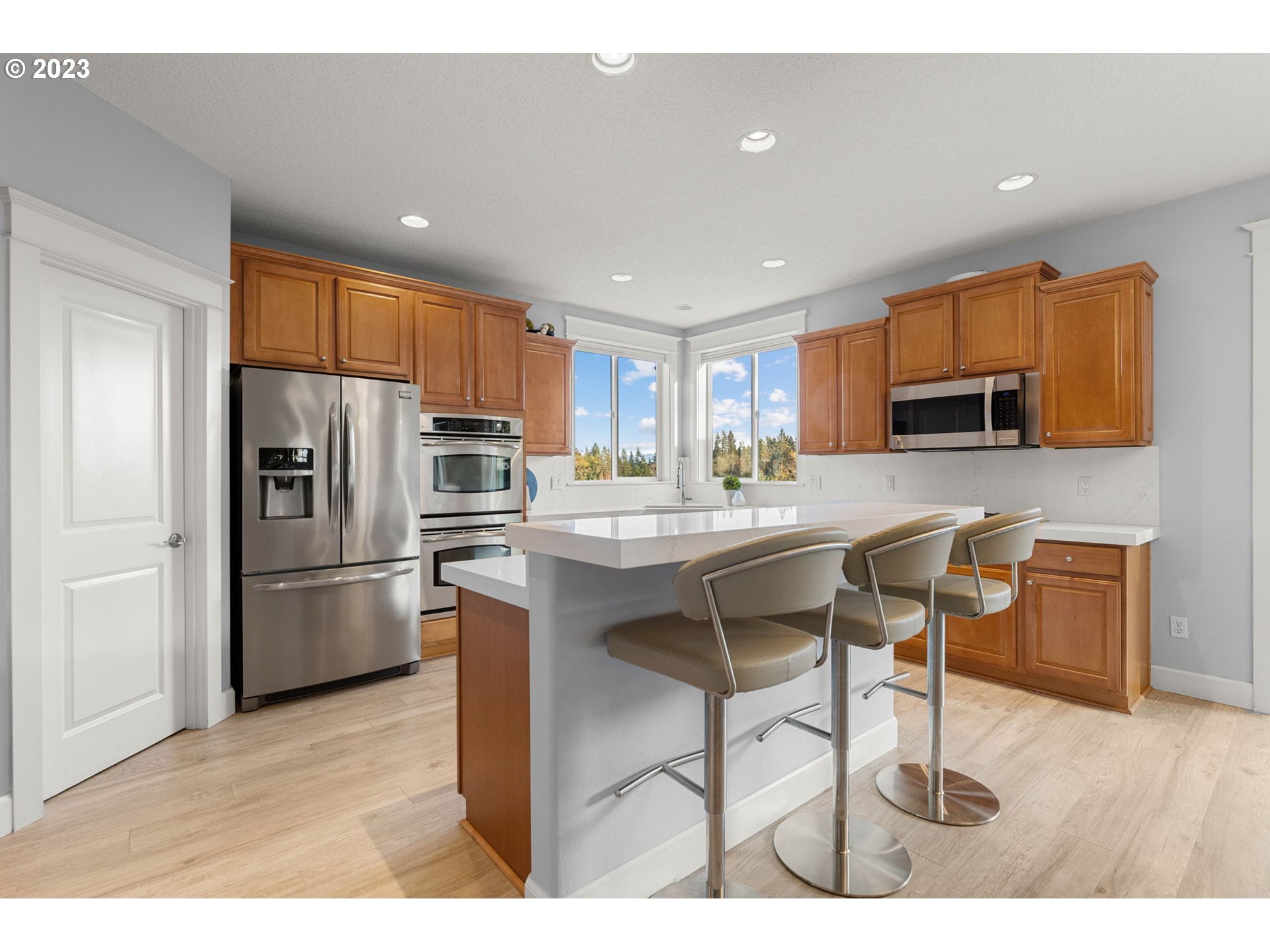 1913 South 15th Circle Ridgefield, WA 98642 - Photo 10 of 33 a kitchen with stainless steel appliances granite countertop a refrigerator a stove a sink a dining table and chairs