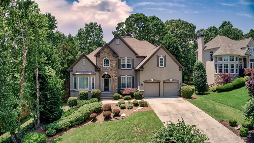 6340 Rutherford Place Suwanee, GA 30024 - Photo 1 of 1 WELCOME HOME! OUTSTANDING CURB APPEAL awaits you with this Hardcoat Stucco and Stone Beauty on the Golf Course with PRIVATE BACKYARD and Golf Views of #1 Fairway/Green/Driving Range!