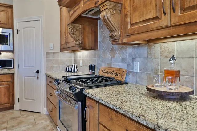 a kitchen with stainless steel appliances granite countertop a stove and a sink