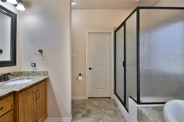 a bathroom with a tub sink and mirror