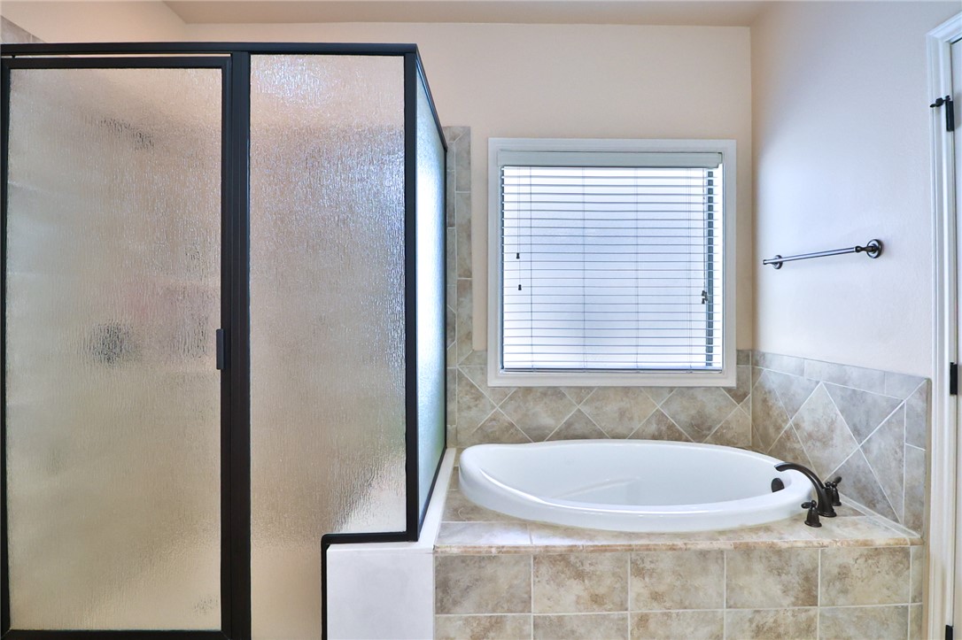 3900 Ambrose Court Bryan, TX 77808 - Photo 22 of 34 a bath tub sitting in a bathroom next to a window