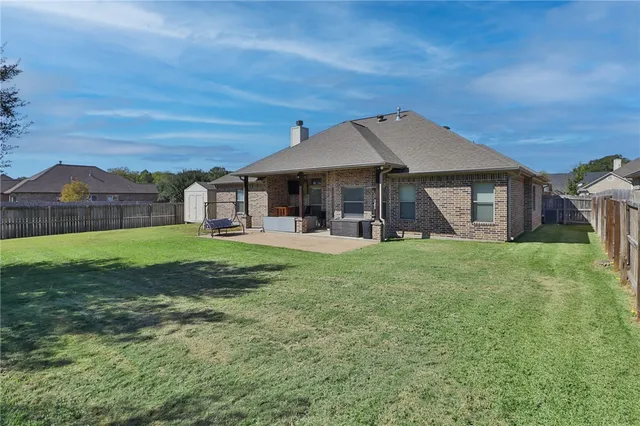 a view of a house with backyard porch and sitting area