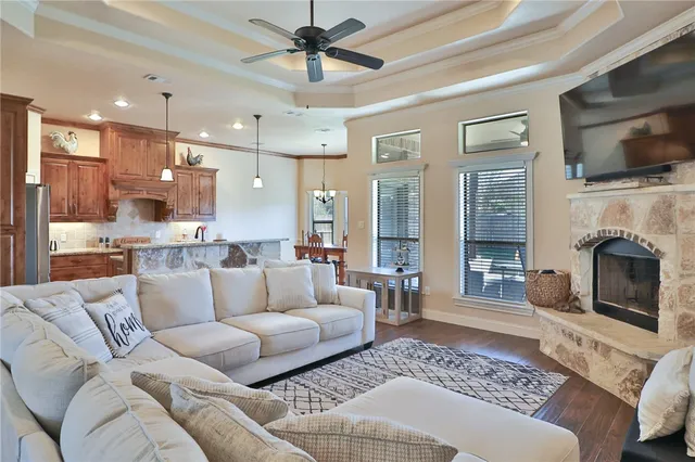 a living room with furniture a flat screen tv and a fireplace