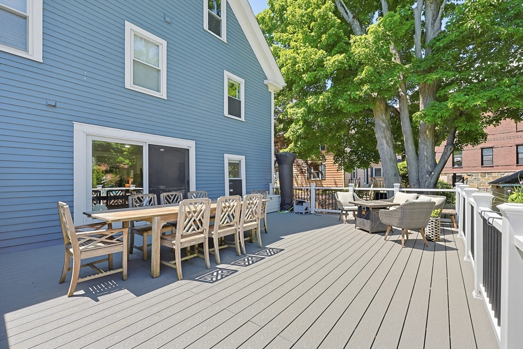 345 Sherman Street Canton, MA 02021 - Photo 35 of 42 a view of a patio with table and chairs and wooden floor