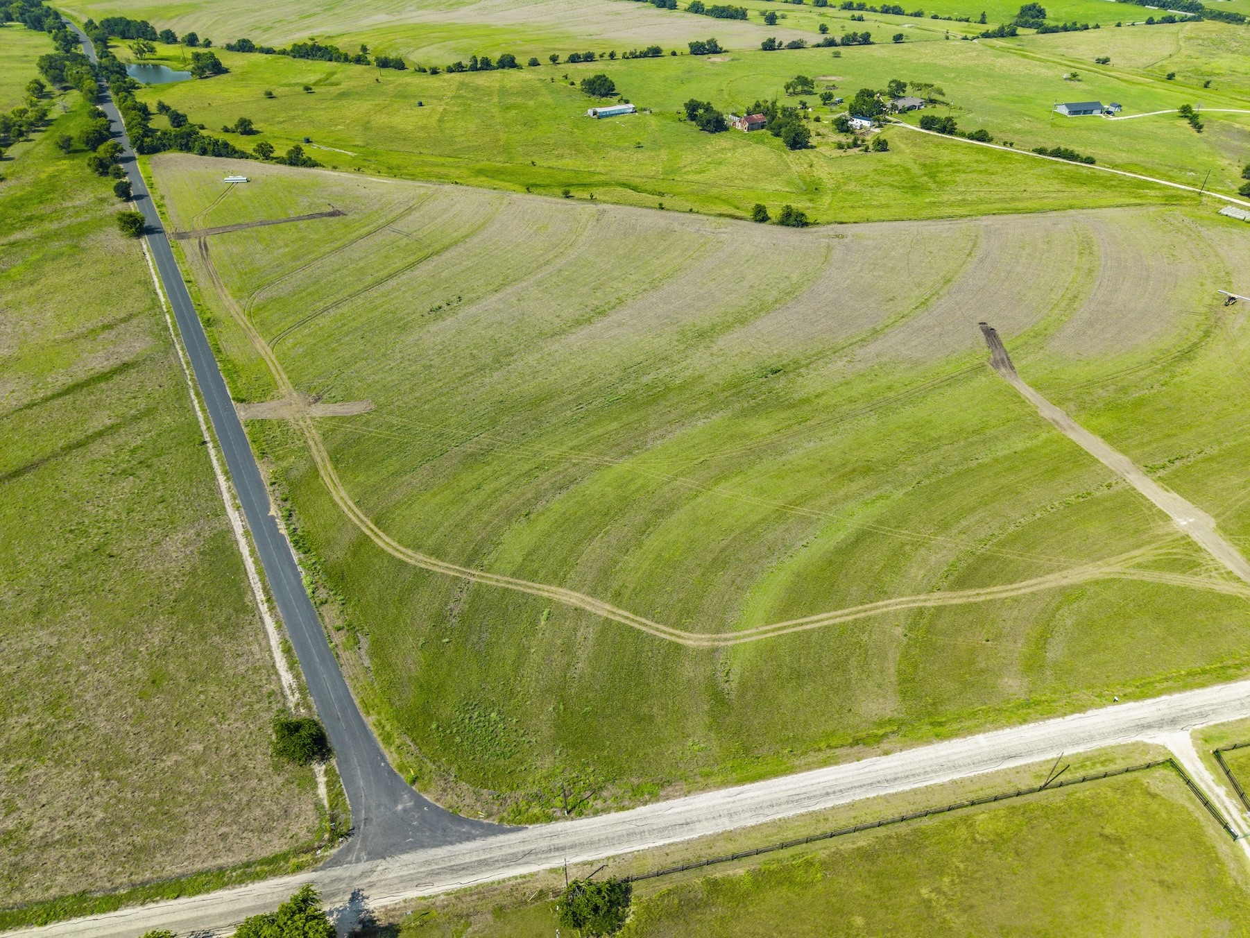 1 County Road 327 Road Granger, TX 76530 - Photo 15 of 27 Vast rolling green pastures and open acreage bordered by country roads define this rural landscape.