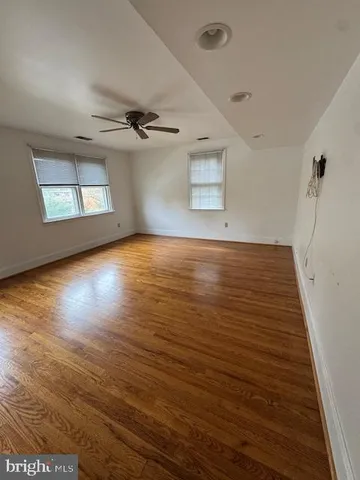 a view of a kitchen with wooden floor and electronic appliances