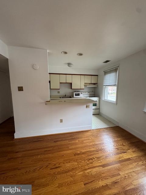 42 Conshohocken State Road, Unit 8D Bala Cynwyd, PA 19004 - Photo 14 of 20 a view of a kitchen with wooden floor and electronic appliances