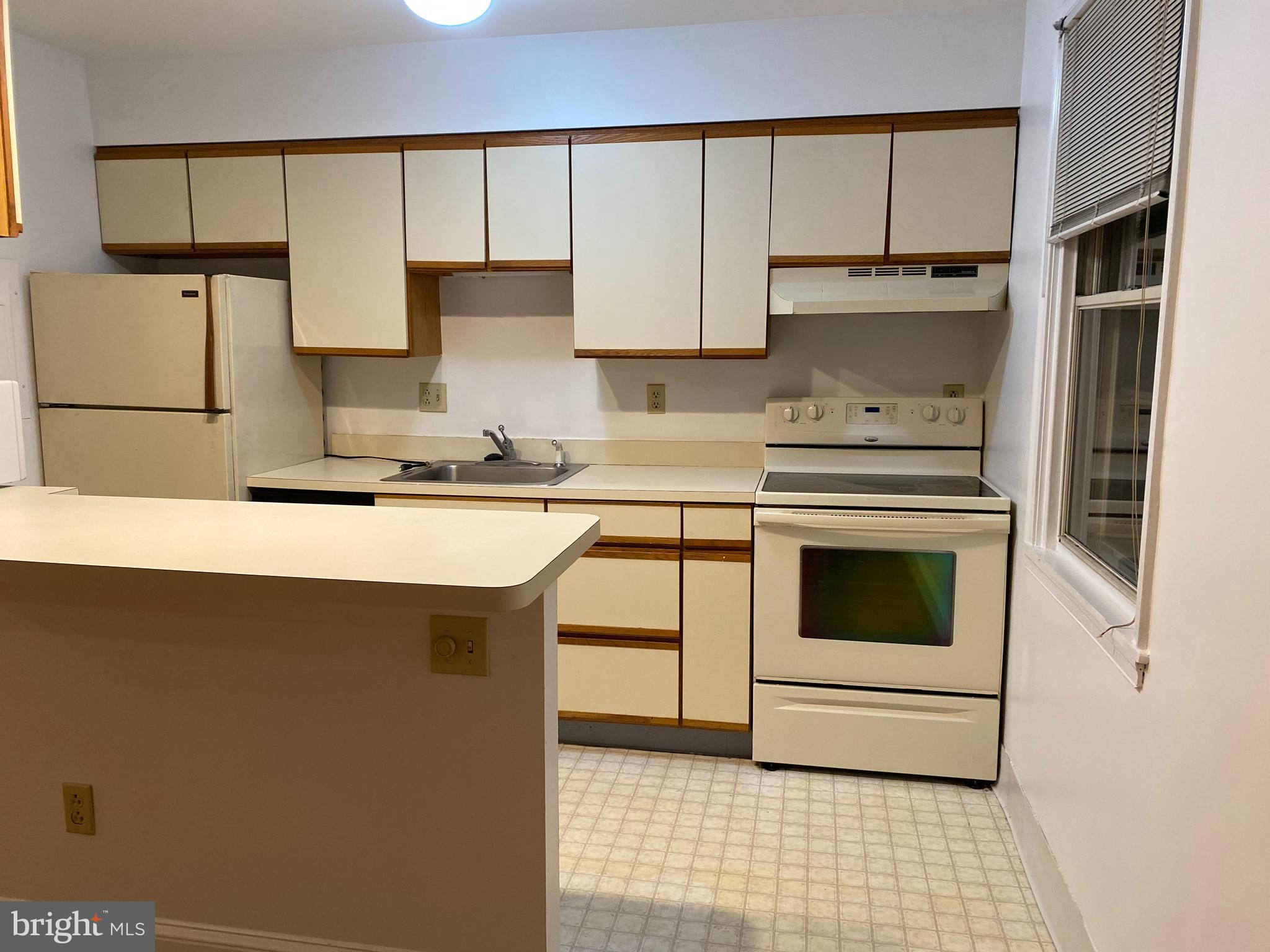 42 Conshohocken State Road, Unit 8D Bala Cynwyd, PA 19004 - Photo 4 of 20 a kitchen with stainless steel appliances a stove sink and cabinets
