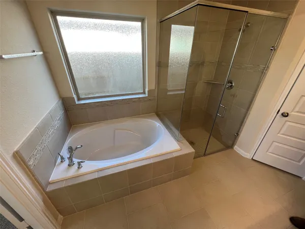 a bathroom with a tub and shower
