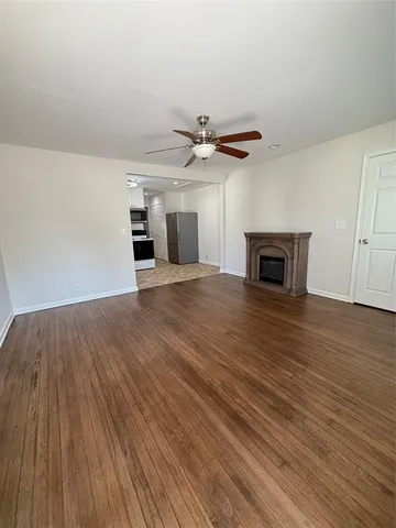 wooden floor in an empty room with a fireplace