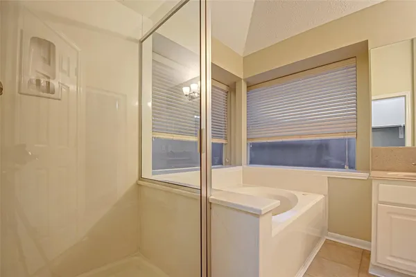 a bathroom with a tub and shower
