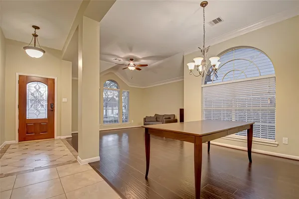 a view of a livingroom with furniture wooden floor and chandelier