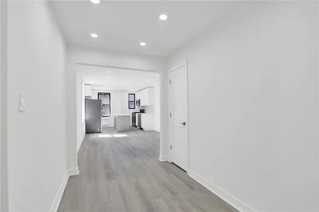 a view of a hallway with wooden floor