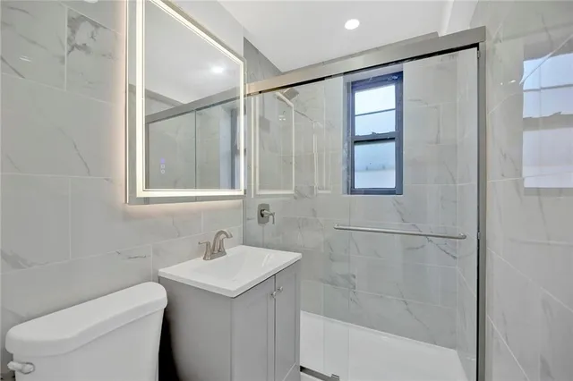 a bathroom with a sink toilet and shower