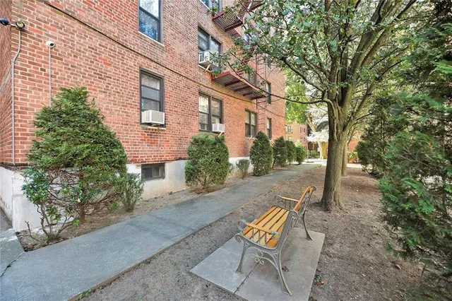 a view of a patio with table and chairs under an umbrella