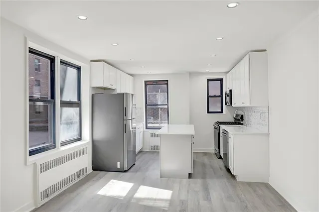 a kitchen with stainless steel appliances a refrigerator and a stove