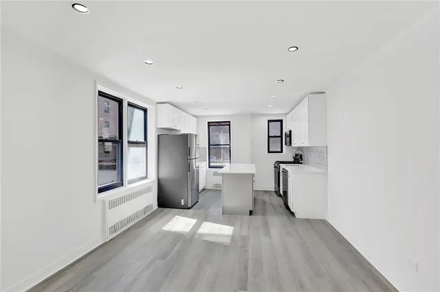 a view of kitchen with furniture and refrigerator