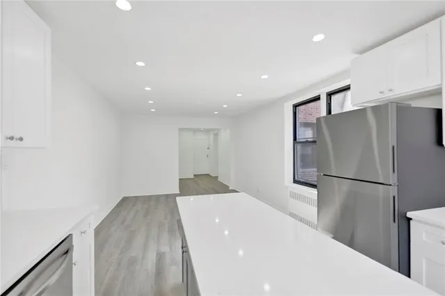 a kitchen with a refrigerator and a refrigerator