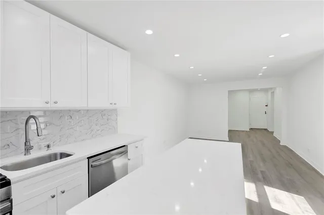 a kitchen with a sink and cabinets