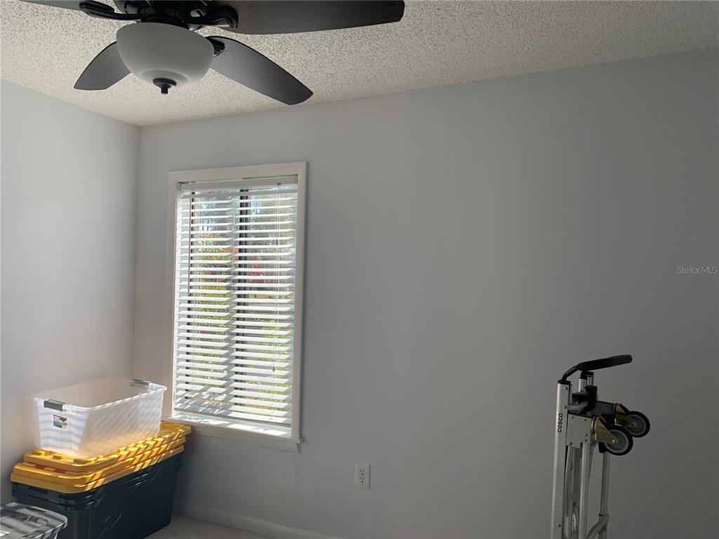 6073 Windhover Drive, Unit C04 Orlando, FL 32819 - Photo 11 of 22 a room with a window and a ceiling fan