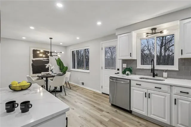 a kitchen with a sink appliances and cabinets