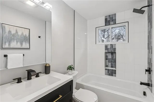 a bathroom with a sink toilet and bathtub