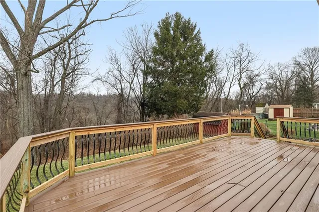 a deck with trees in front of it