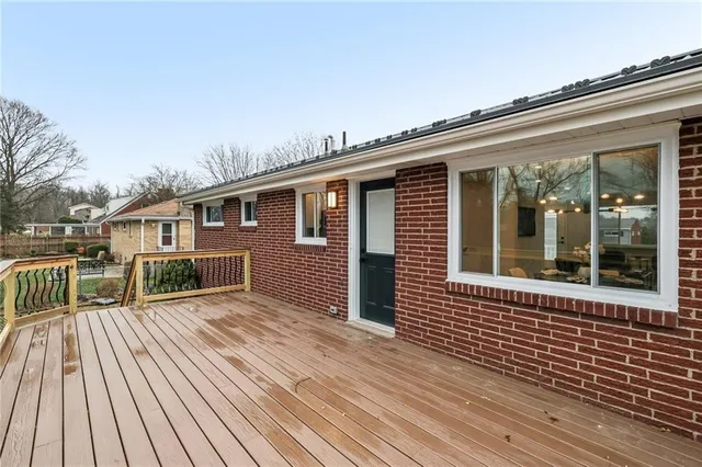 a view of a house with wooden deck