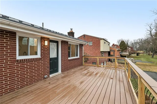 a view of a house with pool and wooden floor
