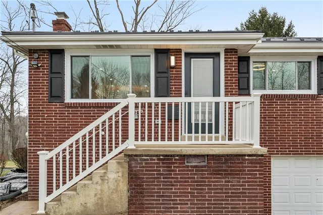 a view of a brick house with large windows