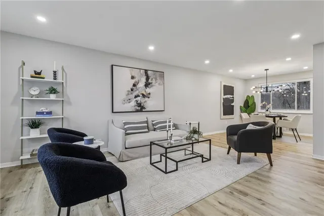 a living room with furniture and a painting on the wall