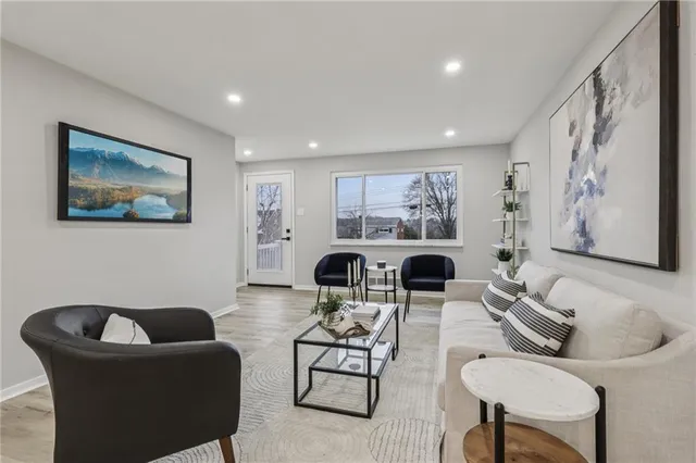 a living room with furniture and paintings on the wall