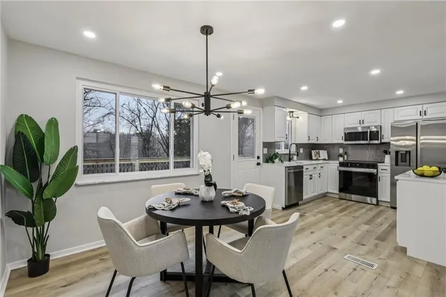 a kitchen with a table and chairs in it