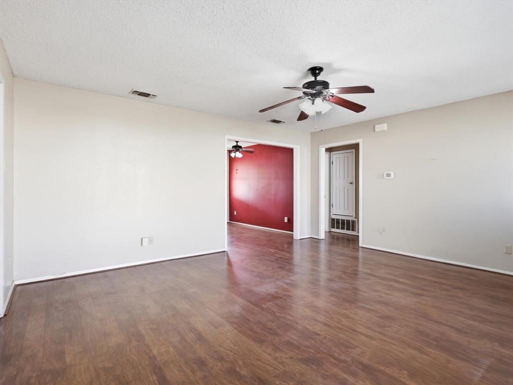 701 College Street Celeste, TX 75423 - Photo 7 of 29 a view of an empty room with a ceiling fan and a window