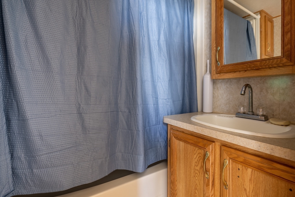 238-242 East Beach Road Westport, MA 02790 - Photo 11 of 29 a bathroom with a sink and vanity