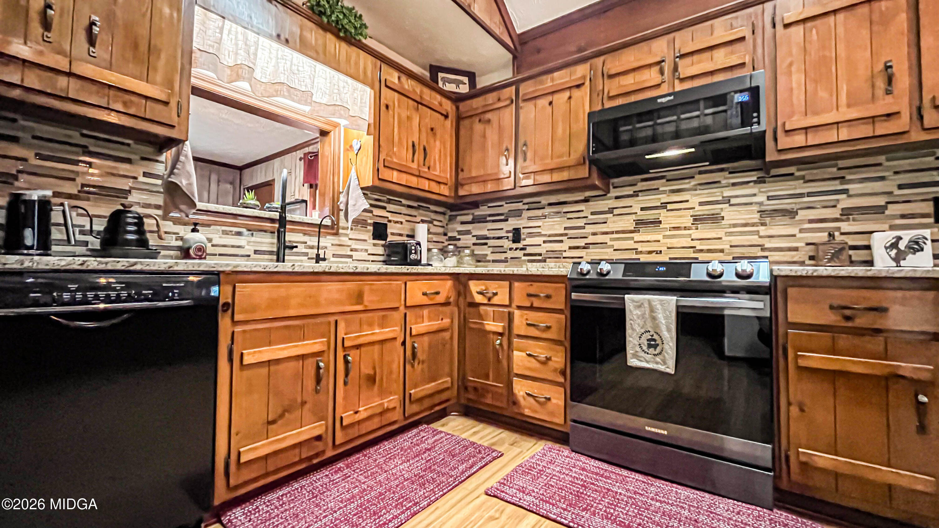 523 Fredonia Church Road Barnesville, GA 30204 - Photo 35 of 78 a kitchen with stainless steel appliances granite countertop a stove a sink and a microwave