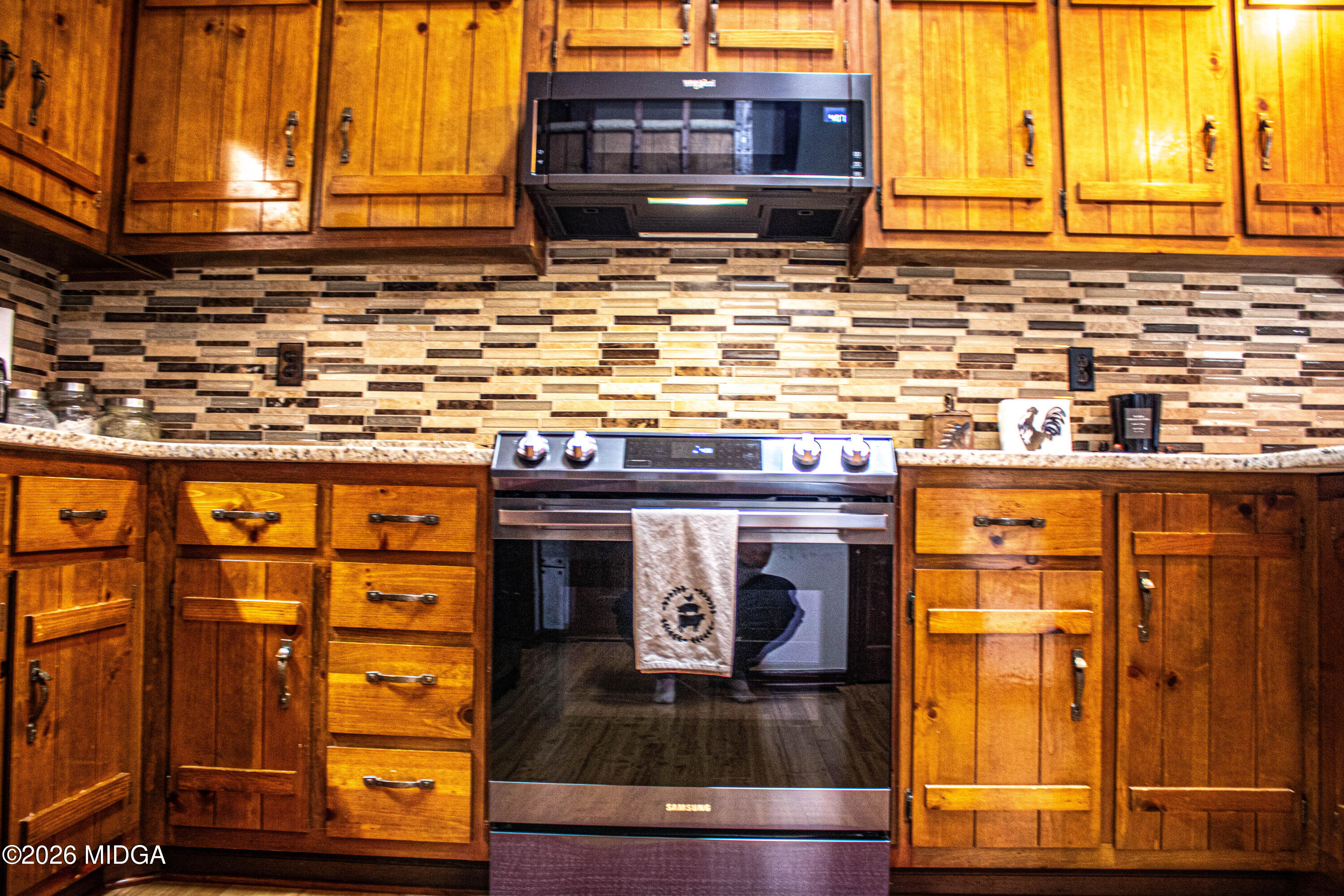 523 Fredonia Church Road Barnesville, GA 30204 - Photo 39 of 78 a kitchen with stainless steel appliances granite countertop a stove and a microwave